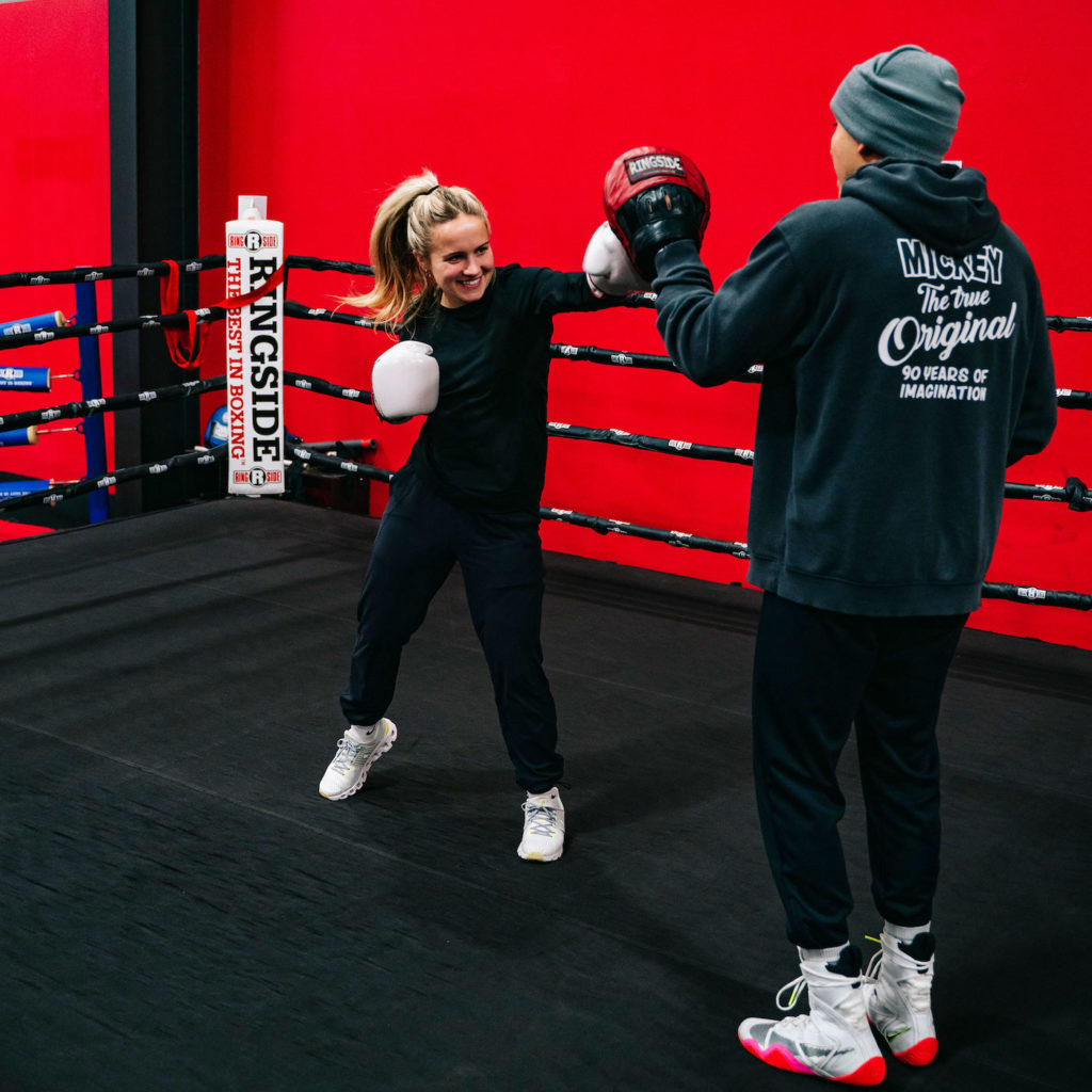 Member With Trainer in Boxing Ring
